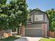 Charming two-story home featuring brick accents, a two-car garage, and a well-manicured lawn at 2548 Foothills Canyon Ct, Highlands Ranch, CO 80129