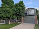 Charming two-story home with a mature shade tree and a well-maintained lawn at 2548 Foothills Canyon Ct, Highlands Ranch, CO 80129