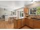 Kitchen flows into dining area and living room with hardwood floors and stainless appliances at 2548 Foothills Canyon Ct, Highlands Ranch, CO 80129
