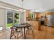 Eat-in kitchen features stainless appliances, granite countertops, wood floors, and a sliding door to the backyard at 2548 Foothills Canyon Ct, Highlands Ranch, CO 80129