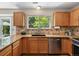 Kitchen features stainless steel appliances, granite countertops, tile backsplash, and a window overlooking the backyard at 2548 Foothills Canyon Ct, Highlands Ranch, CO 80129