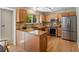 Well-lit kitchen with stainless appliances, granite countertops, tile backsplash, and hardwood floors at 2548 Foothills Canyon Ct, Highlands Ranch, CO 80129