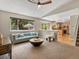 Inviting living room with large window and view to the backyard, plus a modern ceiling fan at 2548 Foothills Canyon Ct, Highlands Ranch, CO 80129