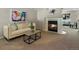 Cozy living room with a fireplace, a comfortable sofa, and stylish decor at 2548 Foothills Canyon Ct, Highlands Ranch, CO 80129