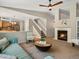 Open-concept living room with a fireplace, stylish seating, and easy access to the kitchen at 2548 Foothills Canyon Ct, Highlands Ranch, CO 80129