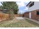 Side yard featuring a garden bed, gravel area, and access to the house with potential for customization and landscaping at 1581 S Kendall St, Lakewood, CO 80232