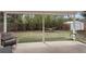 Covered patio area with a hammock and swing in a lush, green backyard at 1581 S Kendall St, Lakewood, CO 80232