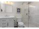 Stylish bathroom featuring a modern glass shower, a vanity sink and bright lighting at 1581 S Kendall St, Lakewood, CO 80232