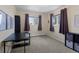 Bright bedroom with large windows, carpet flooring, and black desk at 1581 S Kendall St, Lakewood, CO 80232