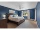 Spacious bedroom with ceiling fan, plush carpet, and a large window at 1581 S Kendall St, Lakewood, CO 80232