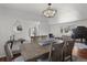 Beautiful dining room featuring a hardwood table, modern lighting, and open floor plan at 1581 S Kendall St, Lakewood, CO 80232