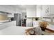 Charming kitchen with white cabinets, stainless steel appliances and a view into the dining room at 1581 S Kendall St, Lakewood, CO 80232