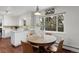 Bright kitchen with white cabinets, stainless steel appliances and a view into the dining room at 1581 S Kendall St, Lakewood, CO 80232