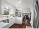 Bright kitchen featuring white cabinetry, stainless steel appliances, and hardwood flooring at 1581 S Kendall St, Lakewood, CO 80232