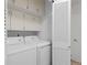 Efficient laundry room featuring a washer, dryer, and ample cabinet space for storage at 1581 S Kendall St, Lakewood, CO 80232