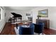 Spacious living room with grand piano and views into adjacent dining room at 1581 S Kendall St, Lakewood, CO 80232