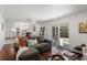 Open-concept living room with hardwood floors, sliding glass doors, and adjacent kitchen at 1581 S Kendall St, Lakewood, CO 80232