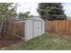Outdoor storage shed with fenced in yard and mature trees at 1581 S Kendall St, Lakewood, CO 80232