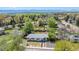 Aerial view of a charming home with a well-manicured lawn and mature trees at 1860 W Iris Cir, Littleton, CO 80120