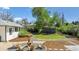 Landscaped backyard with a seating area, gravel paths, and a shed at 1860 W Iris Cir, Littleton, CO 80120