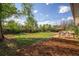 Large backyard featuring a deck, lawn, and multiple seating areas at 1860 W Iris Cir, Littleton, CO 80120