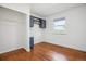 Bedroom with hardwood floors, closet, and built-in storage at 1860 W Iris Cir, Littleton, CO 80120