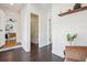 Hallway view showcasing access to living spaces and a bathroom at 1860 W Iris Cir, Littleton, CO 80120