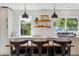 Modern kitchen featuring new stainless appliances, stylish countertops, and wooden island with seating at 1860 W Iris Cir, Littleton, CO 80120