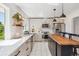 Beautiful kitchen features stainless appliances, stylish countertops, and a functional island with seating at 1860 W Iris Cir, Littleton, CO 80120