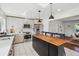 Bright kitchen with stainless steel appliances, island, and white-washed cabinets at 1860 W Iris Cir, Littleton, CO 80120