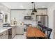 Modern kitchen with stainless appliances, stylish countertops, pendant lighting, and ample counter space at 1860 W Iris Cir, Littleton, CO 80120