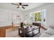 Sun-filled living room with bay windows, hardwood floors and comfortable seating at 1860 W Iris Cir, Littleton, CO 80120