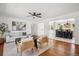 Bright living room featuring hardwood floors, a ceiling fan, and access to the kitchen at 1860 W Iris Cir, Littleton, CO 80120