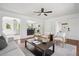 Bright and airy living room with hardwood floors and open concept to kitchen and dining at 1860 W Iris Cir, Littleton, CO 80120