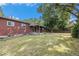 Spacious backyard featuring a covered patio, mature trees, and a well-maintained lawn at 12289 W Dakota Dr, Lakewood, CO 80228