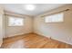 Bright bedroom featuring natural hardwood floors and neutral colored walls at 12289 W Dakota Dr, Lakewood, CO 80228