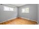 Sunny bedroom with hardwood floors, neutral walls, and large windows at 12289 W Dakota Dr, Lakewood, CO 80228
