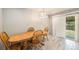 Bright dining room with a wooden table set, stylish lighting, and a sliding glass door at 12289 W Dakota Dr, Lakewood, CO 80228