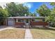Charming brick home with a well-maintained front yard and a detached garage at 12289 W Dakota Dr, Lakewood, CO 80228