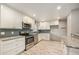 Modern kitchen with stainless steel appliances, white cabinets, and marble counter tops at 12289 W Dakota Dr, Lakewood, CO 80228