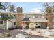 Exterior view of home with stone chimney and stone accents and rock landscaping at 12560 E Warren Dr # E, Aurora, CO 80014