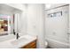 Bathroom featuring vanity, sink, mirror and tub/shower with decorative window at 12560 E Warren Dr # E, Aurora, CO 80014