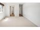 Spacious bedroom with neutral carpeting, windows and entrances to an ensuite bathroom at 12560 E Warren Dr # E, Aurora, CO 80014