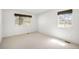 Bright, airy bedroom with two windows offering plenty of natural light and neutral carpeting at 12560 E Warren Dr # E, Aurora, CO 80014