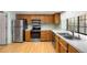 Well-equipped kitchen with stainless steel appliances, wooden cabinetry, and laminate countertops at 12560 E Warren Dr # E, Aurora, CO 80014