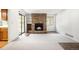 Bright living room showcasing a stone fireplace, built-in shelving and large sliding glass doors at 12560 E Warren Dr # E, Aurora, CO 80014