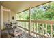 Covered balcony with seating, providing a relaxing outdoor space overlooking lush greenery at 8225 Fairmount Dr # 10-203, Denver, CO 80247