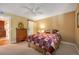 Comfortable bedroom featuring a ceiling fan, and a barn door entrance to an en-suite bath at 8225 Fairmount Dr # 10-203, Denver, CO 80247