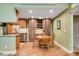 Charming dining area adjacent to the kitchen, featuring built-in cabinets and modern lighting at 8225 Fairmount Dr # 10-203, Denver, CO 80247