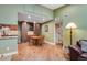 Charming dining area adjacent to the kitchen, featuring built-in cabinets and modern lighting at 8225 Fairmount Dr # 10-203, Denver, CO 80247